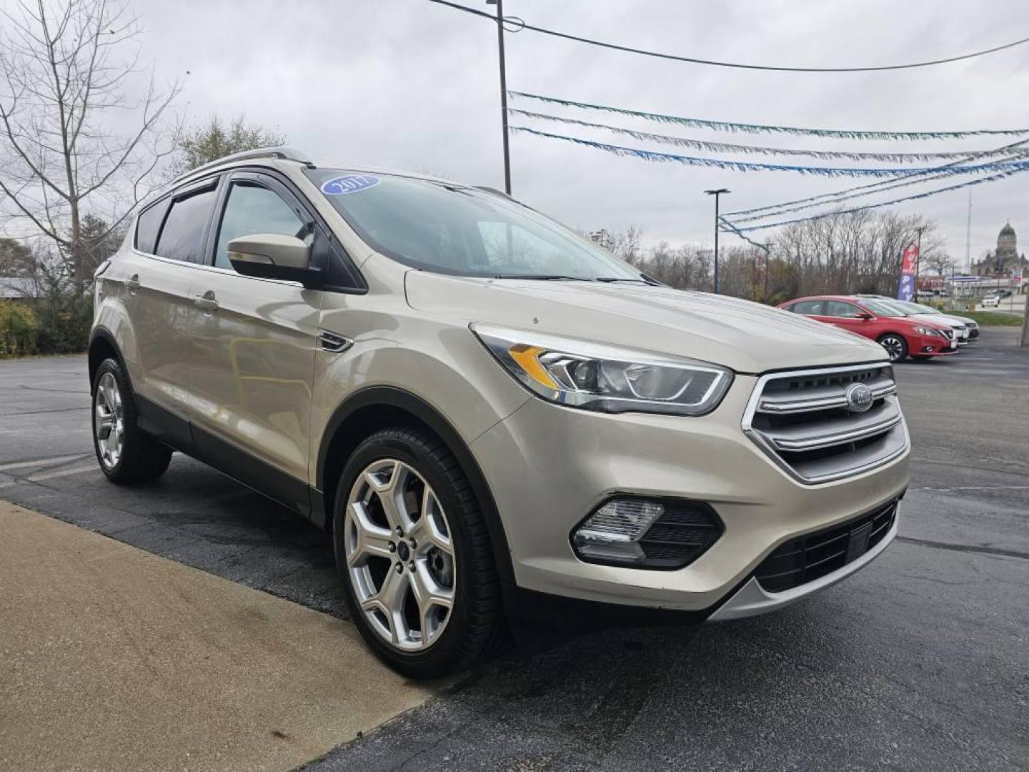2017 GOLD /Tan Ford ESCAPE TITANIUM Titanium FWD (1FMCU0J90HU) with an 2.0L L4 DOHC 16V engine, 6A transmission, located at 502 South Main Street, Columbia City, IN, 46725, (260) 244-4645, 41.151382, -85.490578 - 2017 Ford ESCAPE TITANIUM Titanium FWD - Photo#2