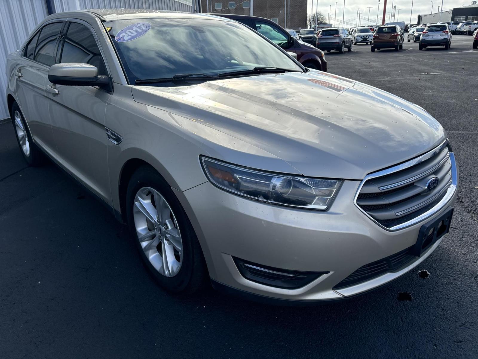 2017 GOLD /Tan Ford TAURUS SEL SEL FWD (1FAHP2E86HG) with an 3.5L V6 DOHC 24V engine, 6A transmission, located at 100 West Coliseum Boulevard, Fort Wayne, IN, 46805, (260) 471-0567, 41.118340, -85.141014 - 2017 Ford TAURUS SEL SEL FWD - Photo#1